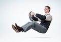 Man accountant with glasses and sleeves is driving a car with steering wheel. Driver concept Royalty Free Stock Photo