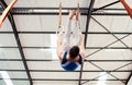 Man, acrobat and gymnastics hanging on rings in fitness for practice, training or workout at gym. Professional male