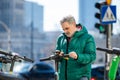 Man activating electric scooter from smartphone Royalty Free Stock Photo