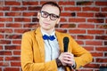 A man actor comedian in glasses, a stylish and tie suit holds a microphone. concept of public speaking Royalty Free Stock Photo