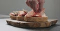 Man add pancetta to slice of ciabatta with fig marmalade Royalty Free Stock Photo