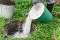 Man is adding a ashes into a pit. Royalty Free Stock Photo