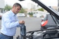 Man adding fluid for cleaning in car Royalty Free Stock Photo