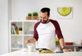 Man adding sugar to cup for breakfast at home Royalty Free Stock Photo