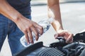 Man adding water to car radiator