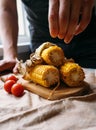 Man adds salt on the roasted corn