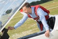 Man adjusting controls on stationary aircraft Royalty Free Stock Photo