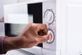 Man Adjusting Temperature Of Microwave Oven Royalty Free Stock Photo