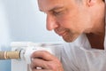 Man Adjusting Temperature Of Radiator Thermostat Royalty Free Stock Photo