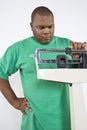 Man Adjusting Weight Scale At Clinic Royalty Free Stock Photo