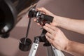 Man adjusts a telescope closeup