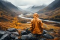 Man admiring beautiful foggy landscape in autumn mountains. Adventurous young man with backpack. Hiking and trekking on a nature Royalty Free Stock Photo