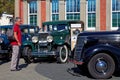 Man admiring vintage cars at a classic car show in Motueka High Street in front of the museum