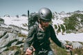 Man adventurer with backpack climbing mountains