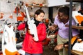 Man advises woman to choose chainsaw at garden tool store Royalty Free Stock Photo