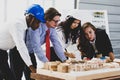 A man African American engineering and caucasian holds coffee. In group meetings Viewing a model building model. Concept