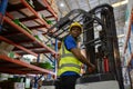 Man african american wear safety helmet driver forklift warehouse in factory. Male worker industrial operate. control loading Royalty Free Stock Photo