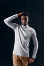 man of african appearance in a gray sweater holding his head fashion studio Royalty Free Stock Photo