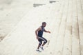 Man african running up flight of stairs, training outdoor while jogging up steps Royalty Free Stock Photo