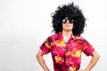 Man with afro wig, sunglasses and Hawaiian shirt, with a boss attitude