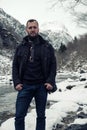 Man against river running from Stalheimsfossen waterfall in Naeroydalen valley, Norway