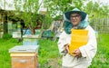 A man aged beekeeper holds in his hands wax in round forms. Beekeeping work on the apiary. Selective focus. Royalty Free Stock Photo