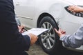 Man agent Filling Insurance Form Near Damaged and examining Car, Traffic Accident and insurance concept Royalty Free Stock Photo