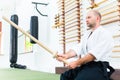 Man at Aikido martial arts with wooden sword Royalty Free Stock Photo