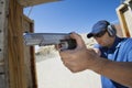 Man Aiming Hand Gun At Firing Range Royalty Free Stock Photo