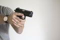 Man Aiming Handgun From Holster In Self Defense