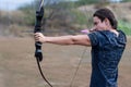 Man aiming for his target at a outdoor archery, holding a bow and arrow Royalty Free Stock Photo