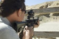 Man Aiming Rifle At Firing Range