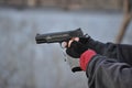 Man Aiming and Shooting .45 Caliber 1911 Hand Gun with Gloves Royalty Free Stock Photo