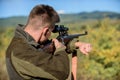 Man aiming target nature background. Aiming skills. Hunter hold rifle aiming. On my target. Bearded hunter spend leisure Royalty Free Stock Photo