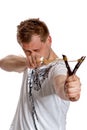 A man aims a slingshot Royalty Free Stock Photo