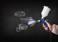 Man with airbrush spray paint with car, boat and motorcycle draw Royalty Free Stock Photo