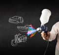 Man with airbrush spray paint with car, boat and motorcycle draw Royalty Free Stock Photo