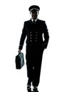 Man in airline pilot uniform silhouette walking Royalty Free Stock Photo