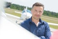 Man with airplane in background Royalty Free Stock Photo