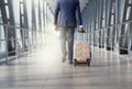 Man at airport moving to terminal gate for business trip, back view Royalty Free Stock Photo