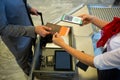 Man at airport showing documents and smartphone with covid 19 vaccine passport at check in