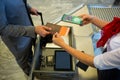 Man at airport showing documents and smartphone with covid 19 vaccine passport at check in