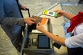 Man at airport showing documents and smartphone with covid 19 vaccine passport at check in