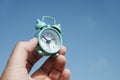 Man with an alarm clock in his hand outdoors Royalty Free Stock Photo