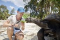 Man with Aldabra giant tortoise Royalty Free Stock Photo