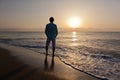 Man alone on beach watching the sunset Royalty Free Stock Photo