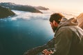 Man alone on the edge cliff above sea looking down Royalty Free Stock Photo