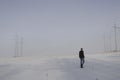 Man alone foggy snowy field day alone