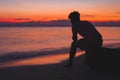 Man alone Lonely by the ocean. At the time the sun Royalty Free Stock Photo