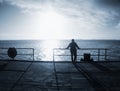 Man alone stay on sea bridge and watch the amazing sunrise Royalty Free Stock Photo